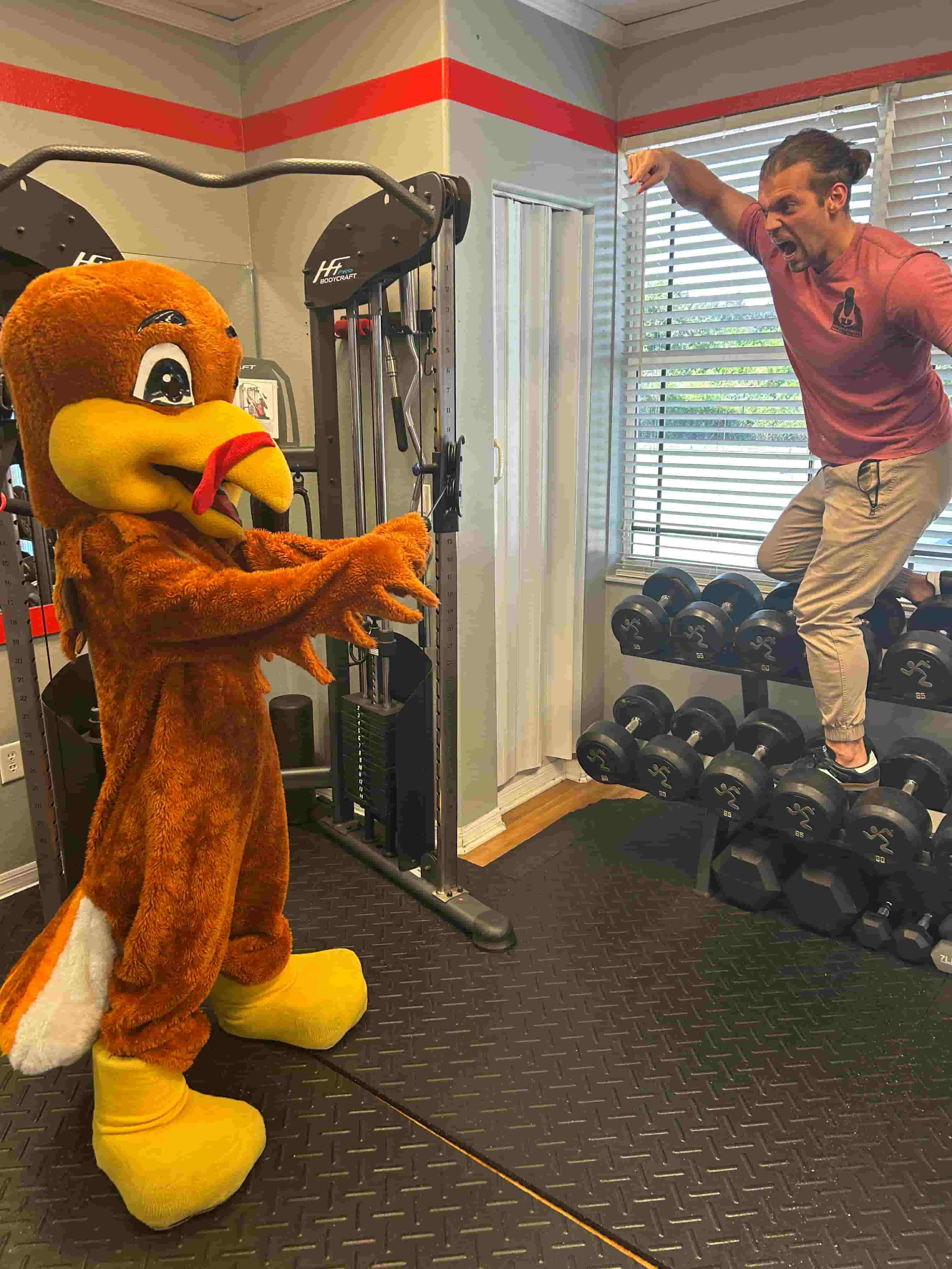 Before the Turkey Trot, the event turkey mascot visited Heroes Fitness while Connor coached the bird through a playful training session for photos